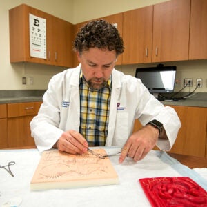 A Nursing student practices at the Boise State lab