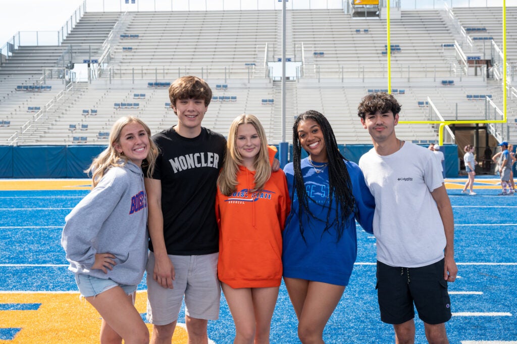 Students taking a picture on the Blue Turf