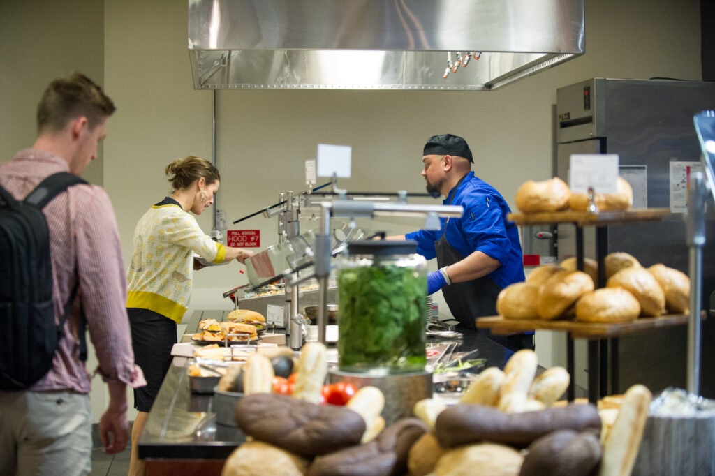 Students at tasting event in a dining hall.