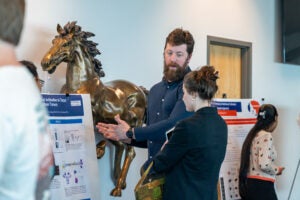 two people discuss poster