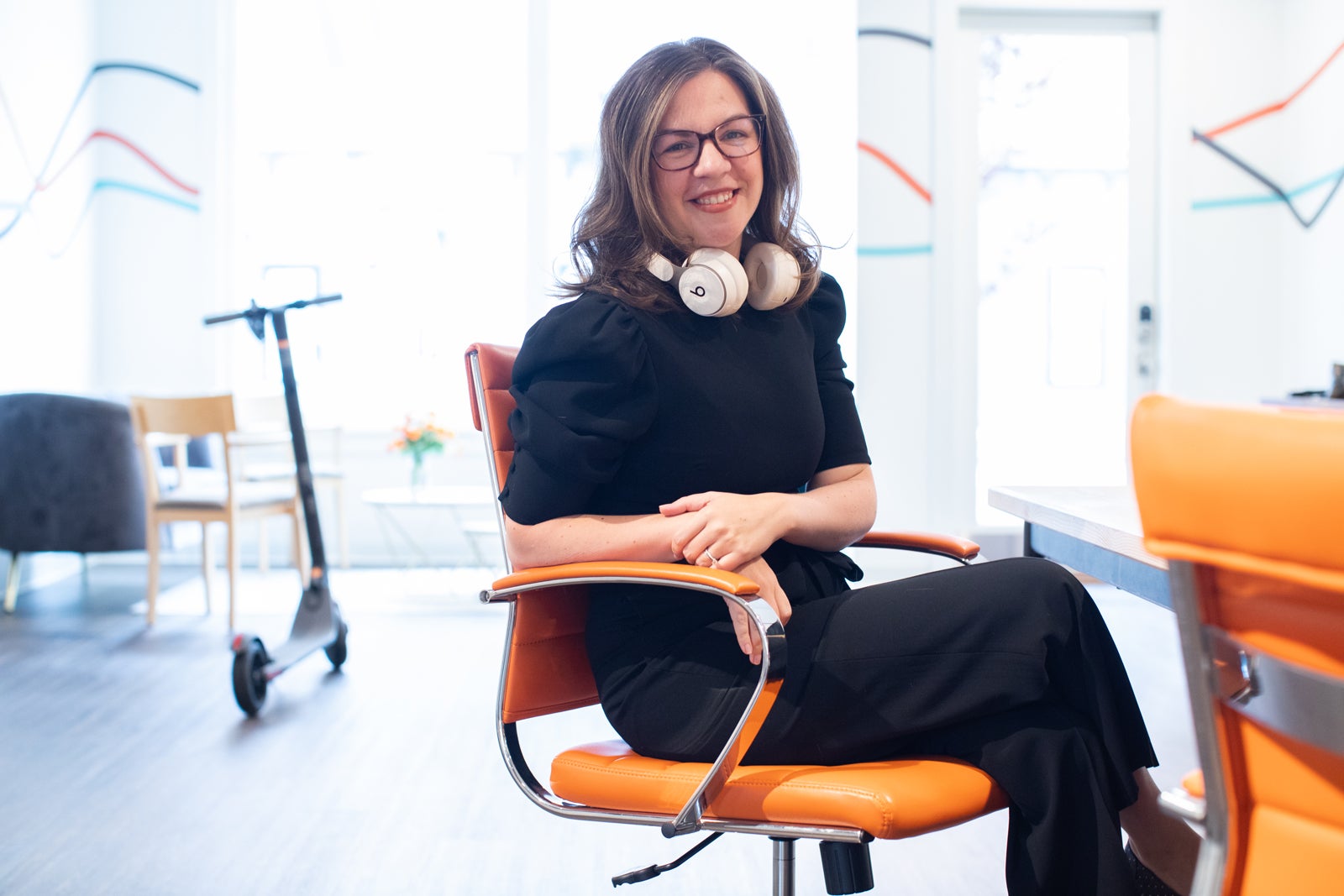 Whitney sitting in an office chair