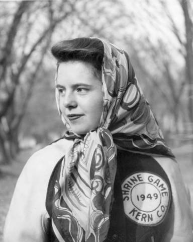 A woman wearing a head scarf and an athletic jacket