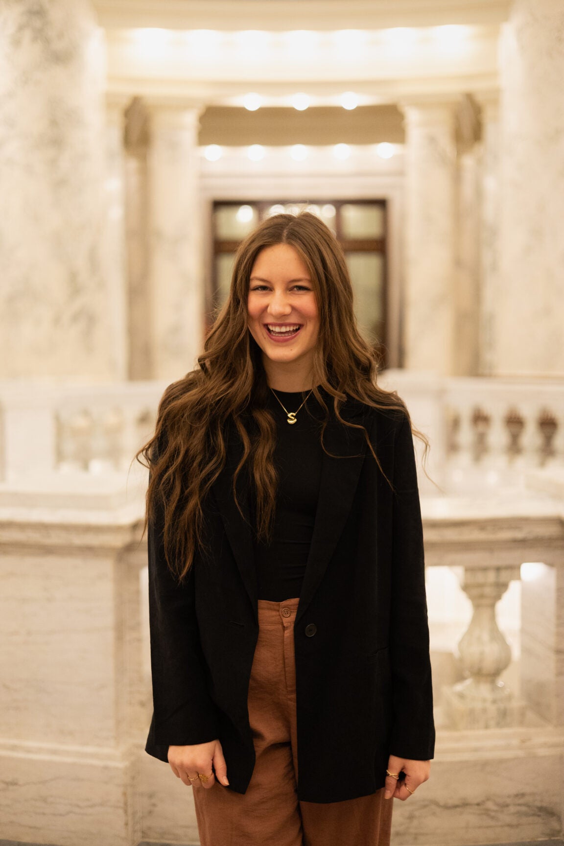 Stella Baron standing in the Idaho Capitol Rotunda, smiling
