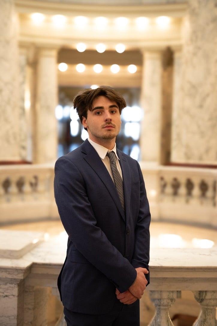 Luke Momberg standing in the Idaho Capitol Rotunda, hands folded in front of him