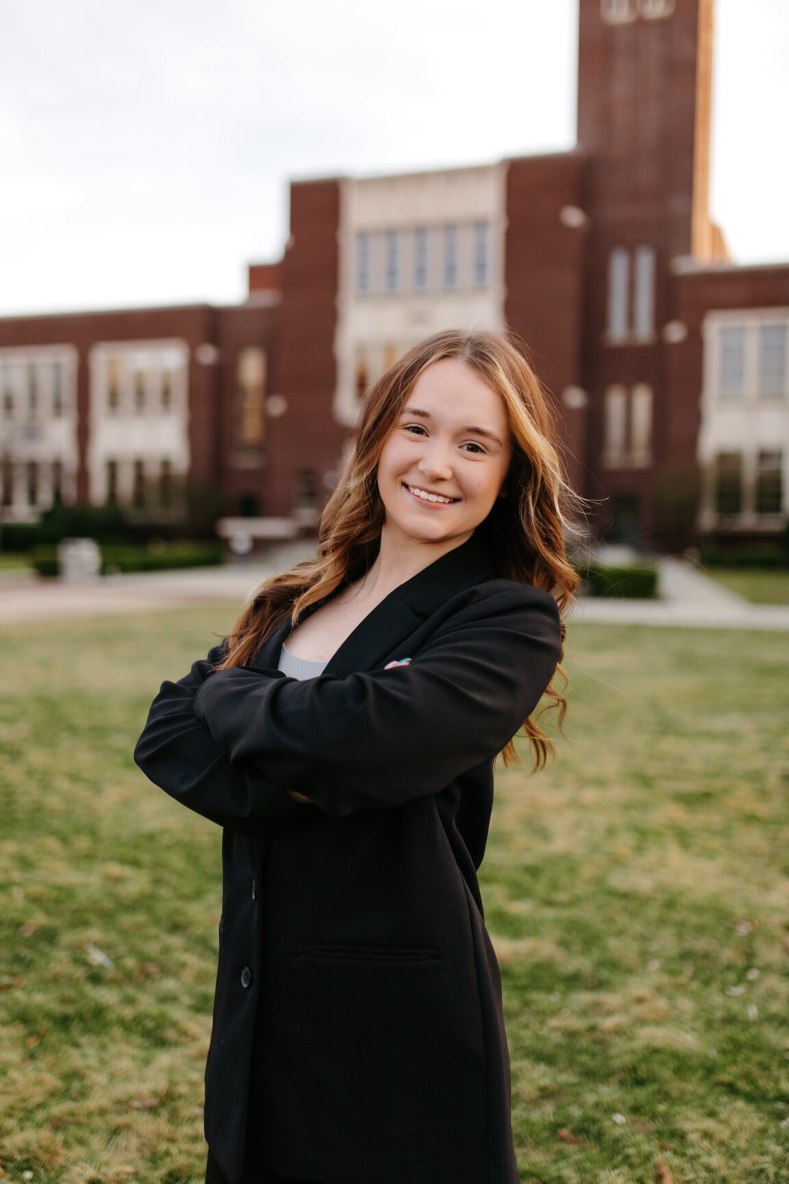 Delana Legault standing in front of a brick building, smiling