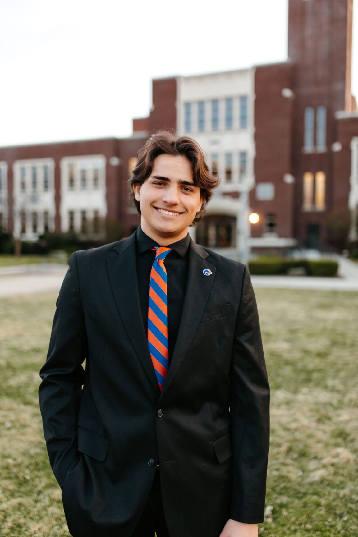 Dimitri Sydoruk standing in front of a brick building, smiling