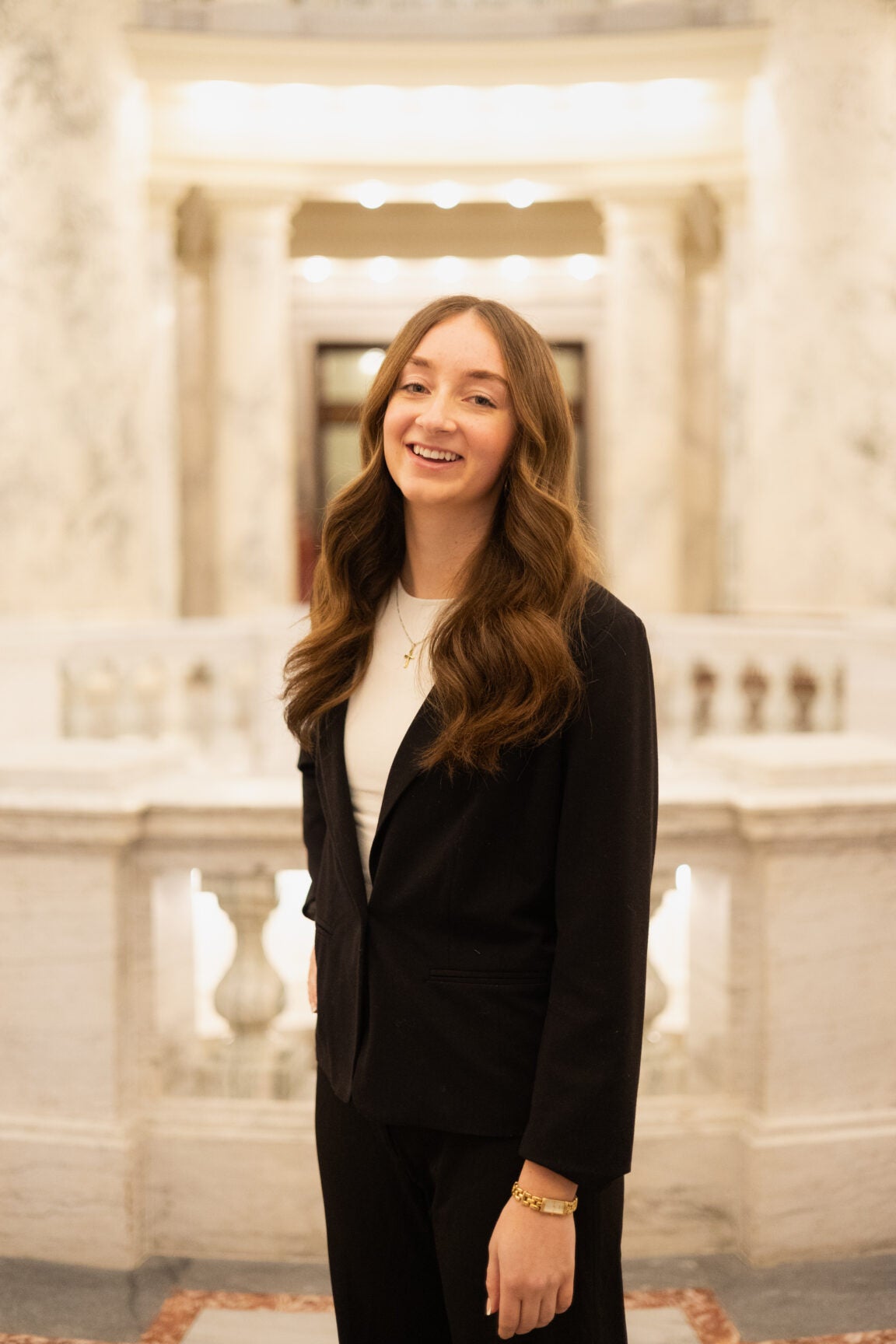 Rachel Lester standing in the Idaho Capitol Rotunda, smiling