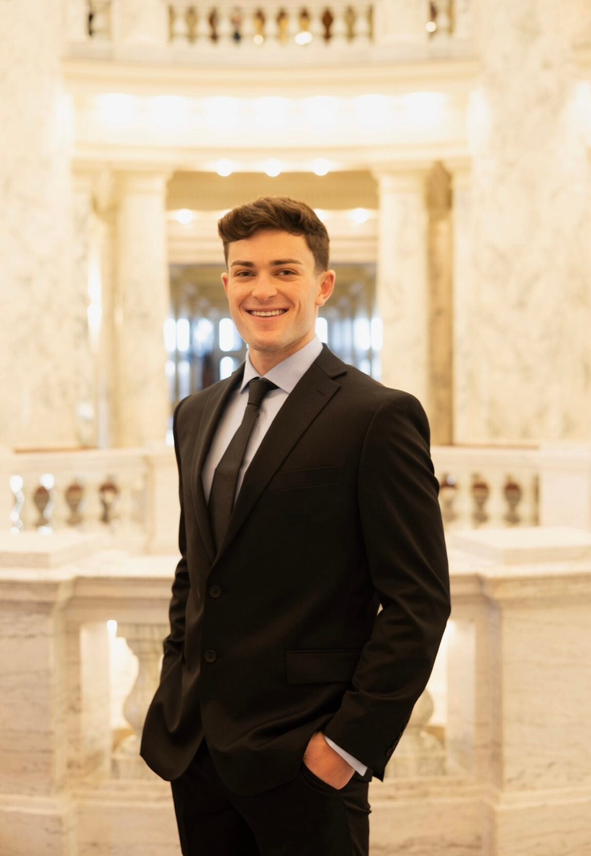 Ivan Perkins standing in the Idaho Capitol Rotunda, smiling