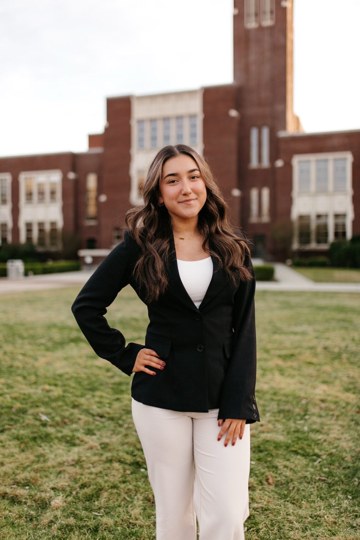 Marissa Nunez standing in front of a brick building, smiling