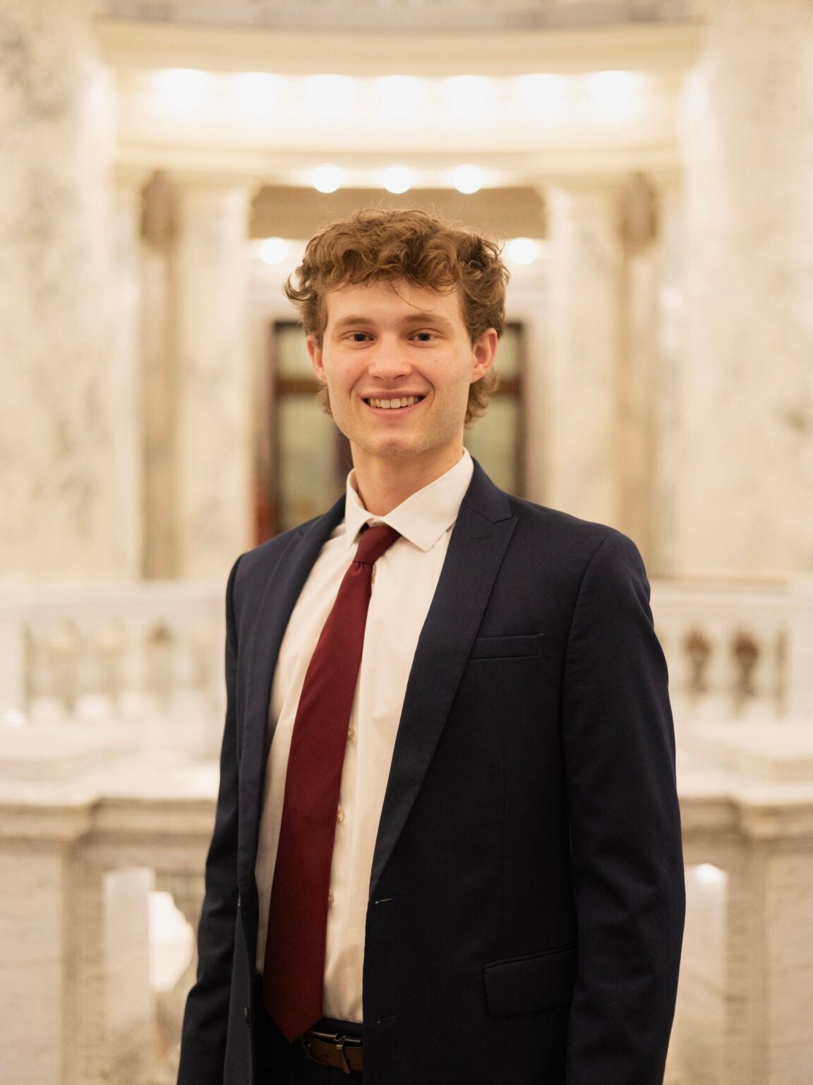 Carson Cole standing in the Idaho Capitol Rotunda, smiling