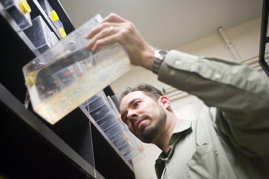 Allan Albig holding a rectangular container filled with clear fluid