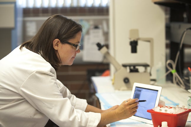 researcher working on a tablet in lab