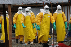Doctors in full protective equipment, walking through village