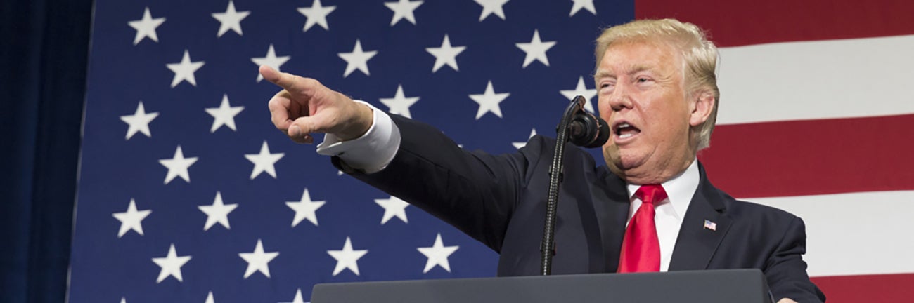 Donald Trump pointing at crowd from podium