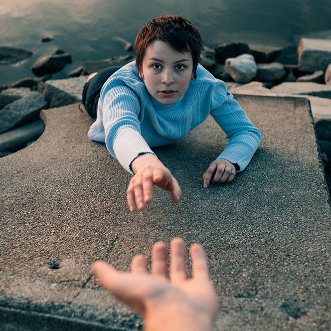 person reaching out for another hand