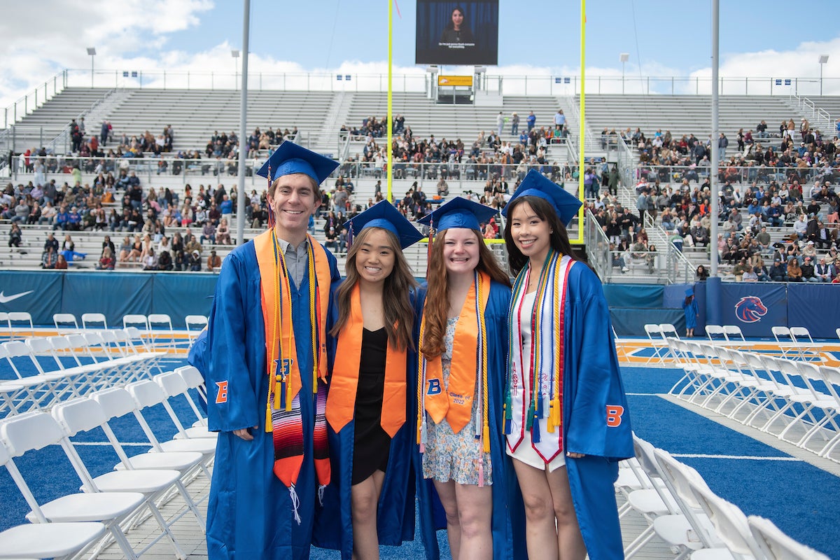 Four graduating students pose for a picture.