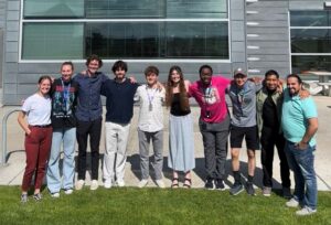Group of students posing in front of building