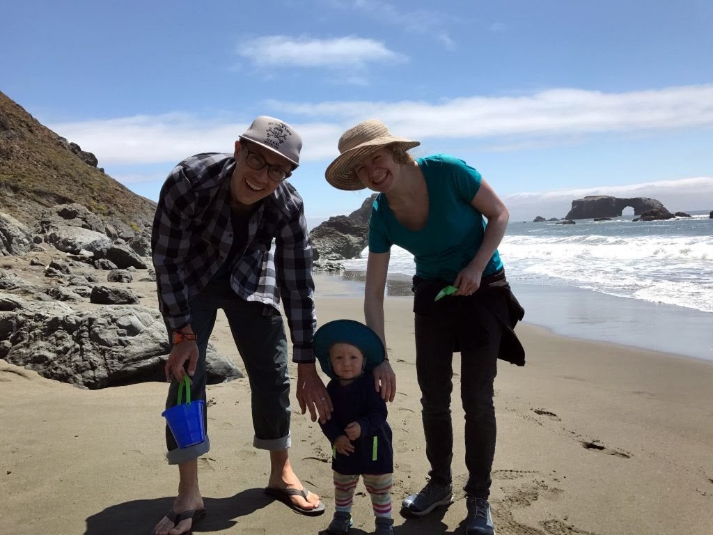 Joe Meredith and family standing on a sandy beach
