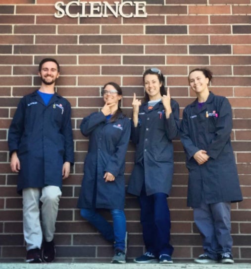 Group of 4 stockroom employees outside of the science building