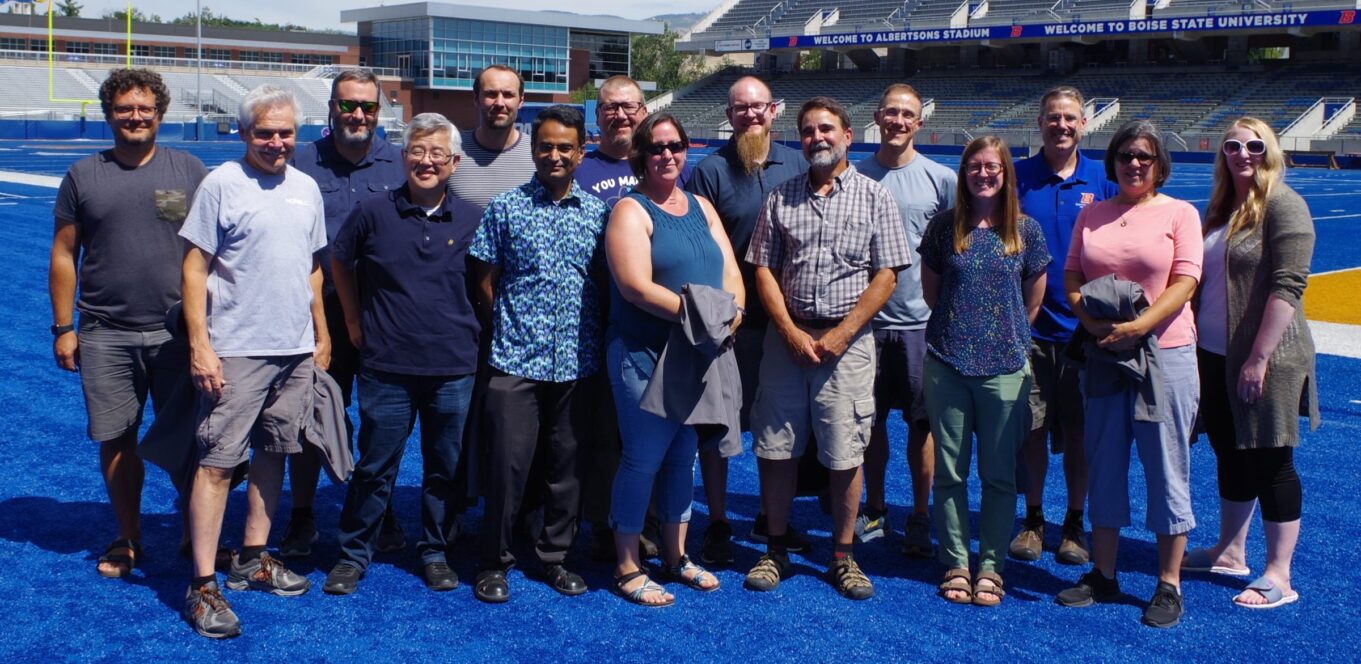 Group photo faculty on the blue turf at Albertsons Stadium