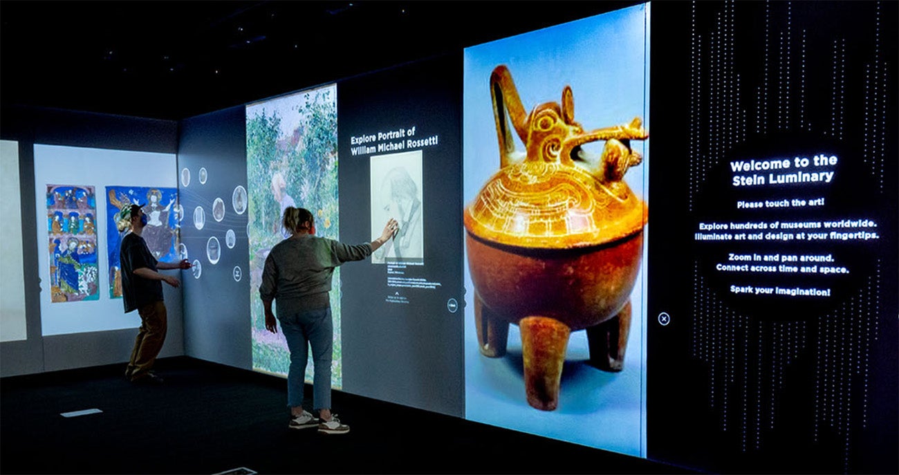 a man and woman looking at artwork in the Stein Luminary