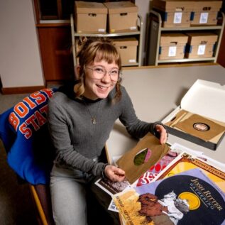 Cora Lee Oxley handling records in archive room