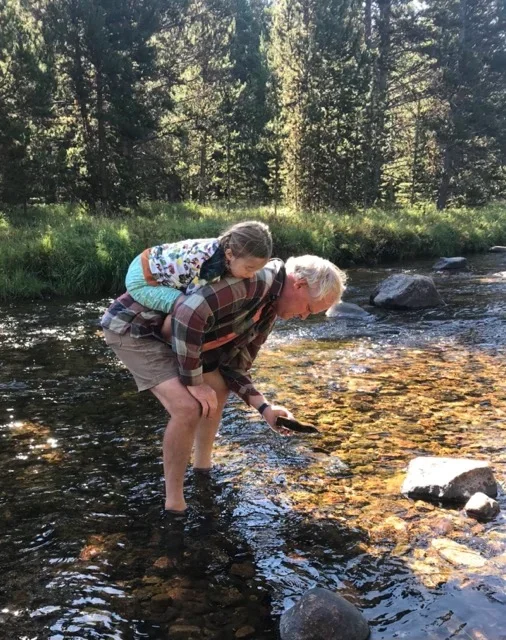 Eric's granddaughter on his back while looking for aquatic macroinvertebrates.