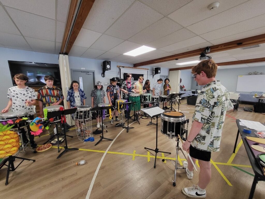 Cameron Repp instructs young drummers at the All-Star Drumline Camp. 