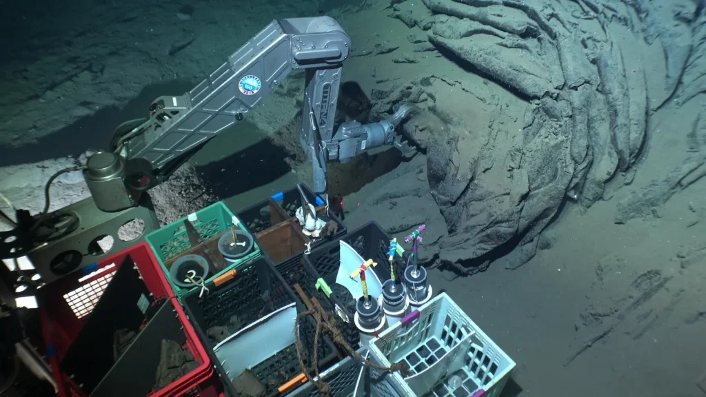 Collecting a basalt sample from the sea floor with Alvin’s arm