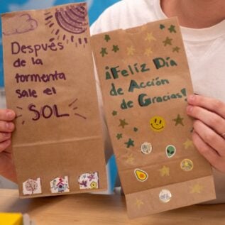 Well-wishing cards that Boise State Spanish students created on brown paper.