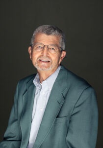 John McGown - man in suit jacket with button up shirt