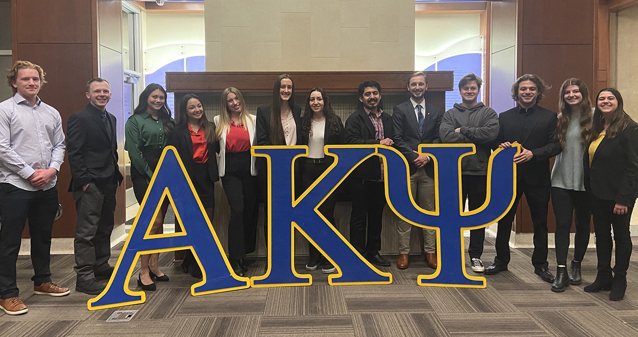 AKPsi members hanging out in the Jackson Commons in the Micron Business and Economics Building