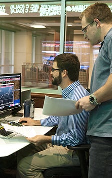 finance students working on Bloomberg terminal