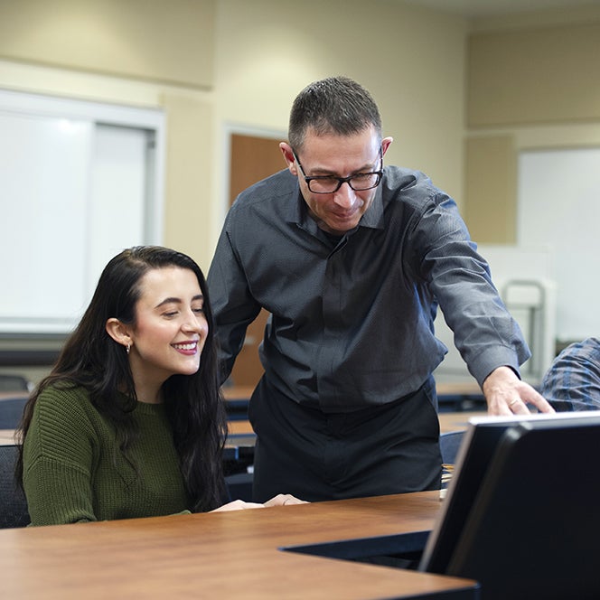supply chain professor working with a student