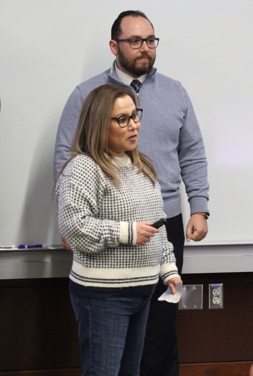 Female MBA student talking to the audience from the front of the classroom