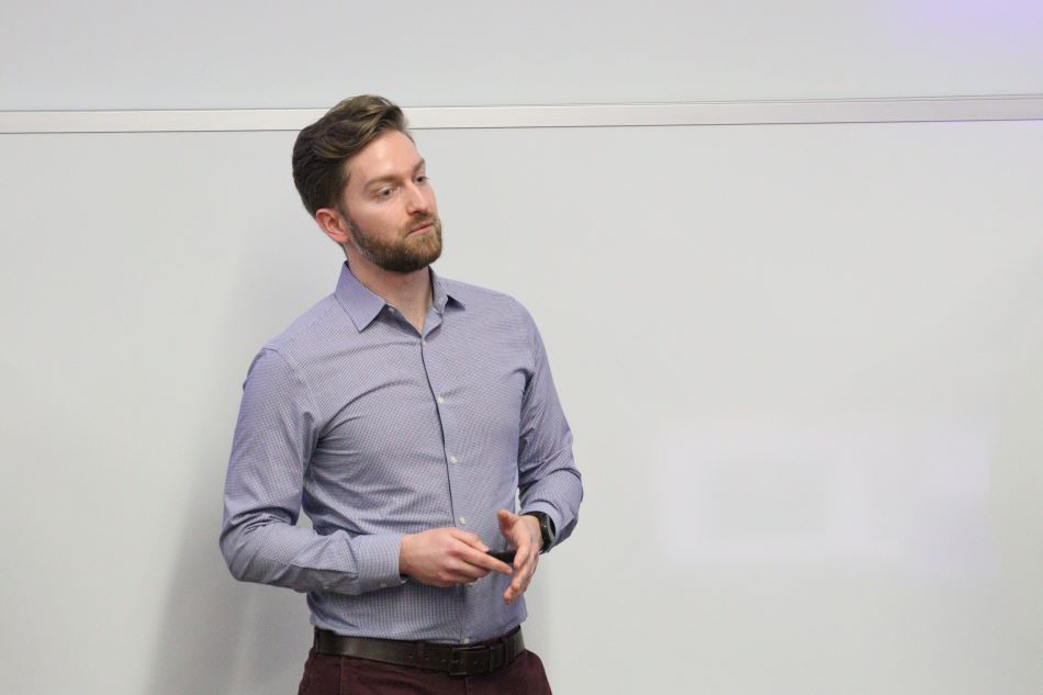 Student talking to audience from the front of classroom