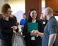 students talking with employer at career fair
