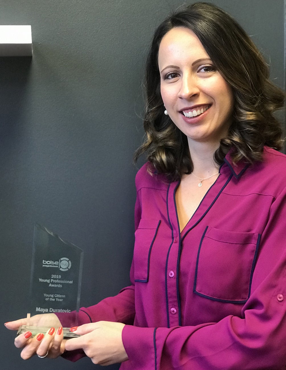 Maya Duratovic holding her Young Professianal of the Year award