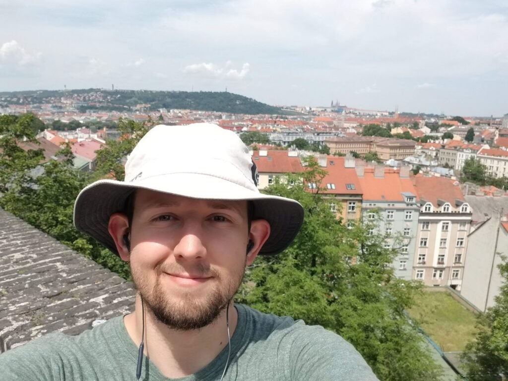 Selfie of Dan Kondratyuk with a beautiful city behind him.