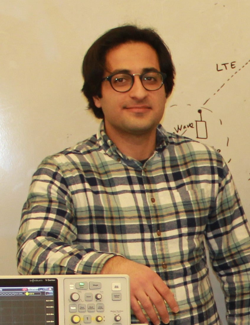 ECE PhD students pose in lab