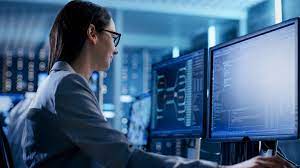 woman looking at a computer monitor