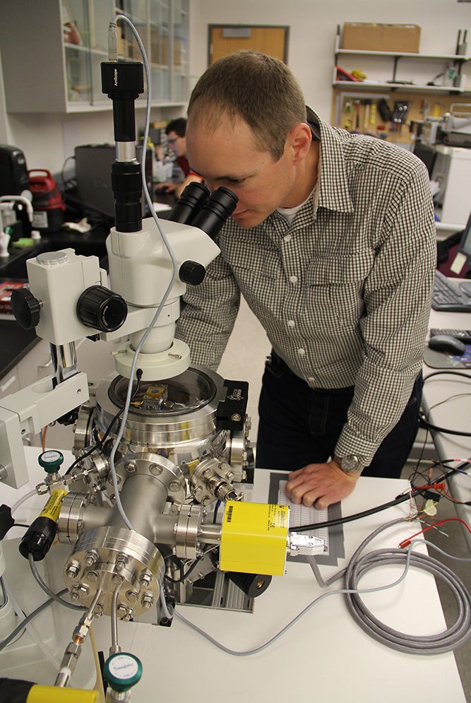 Someone looking into a microscope