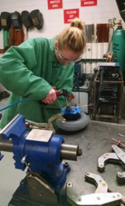 Female student in machine shop