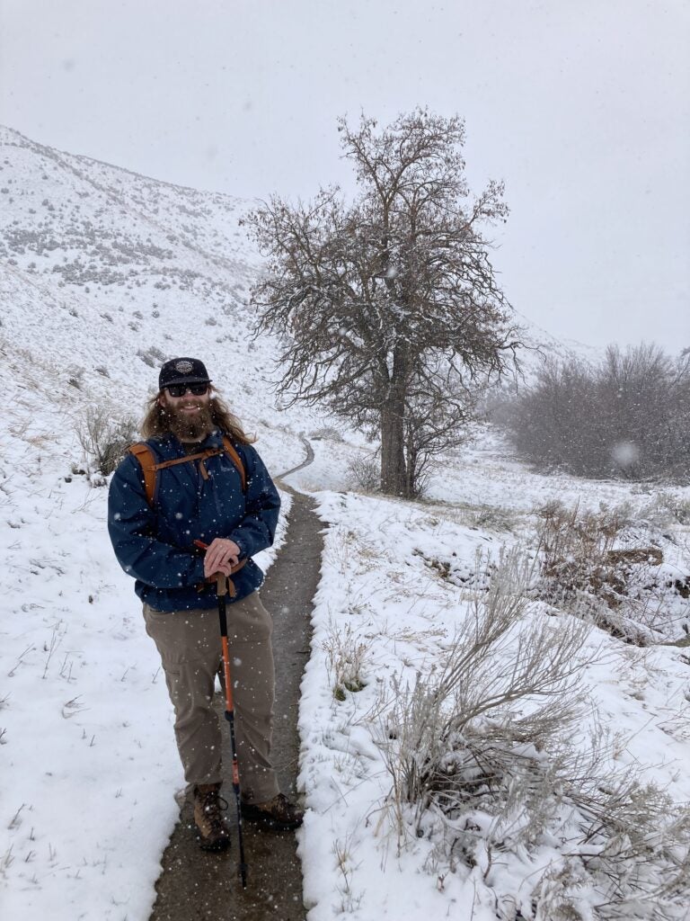 Mac standing along a snowy trail