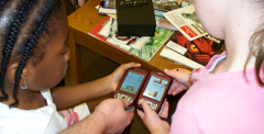photo of kids looking at a smart phone