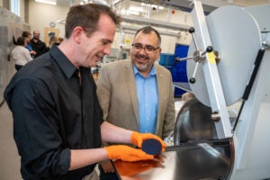 Two men conversing in a lab