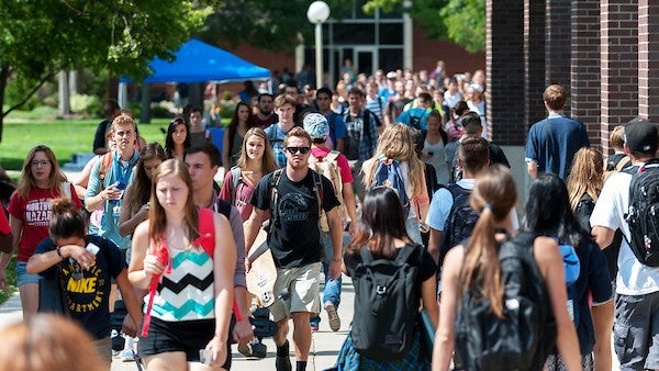 Crowd of students walking across campus