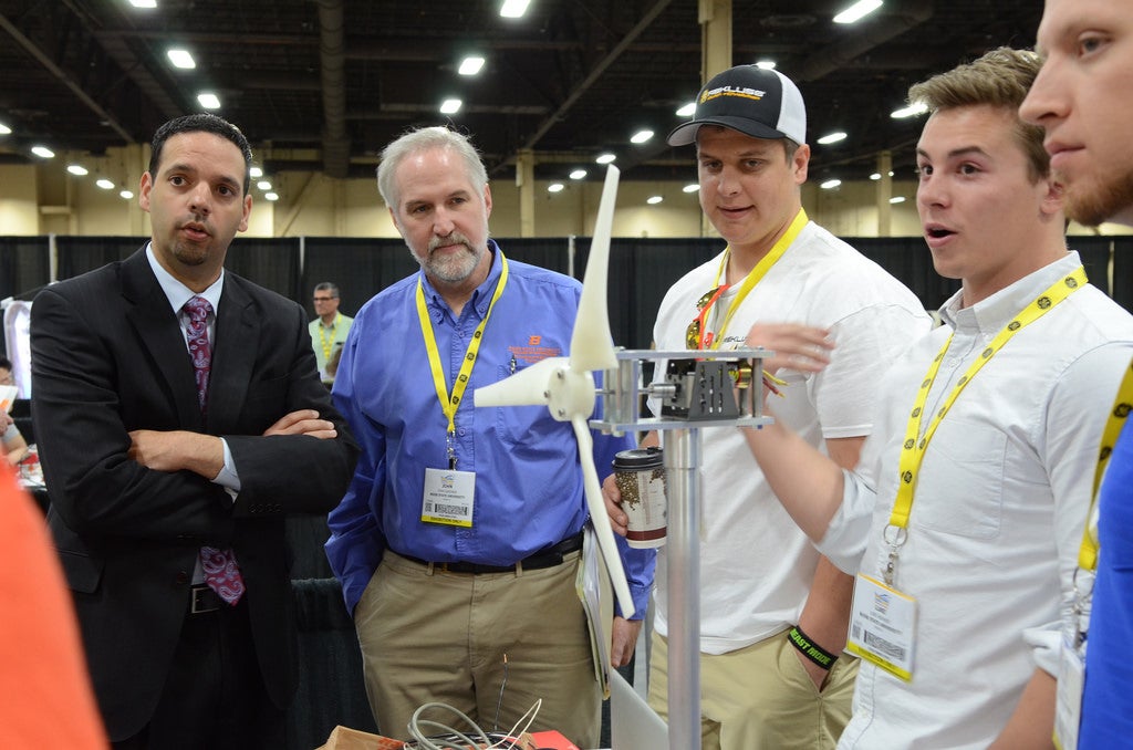 students explain their wind turbine model to judges