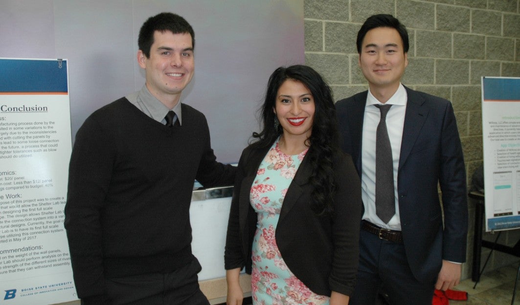 Capstone Design students standing in front of research posters