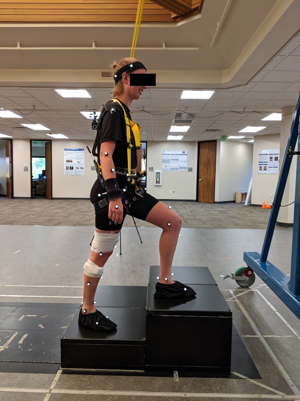 woman with sensors climbing steps